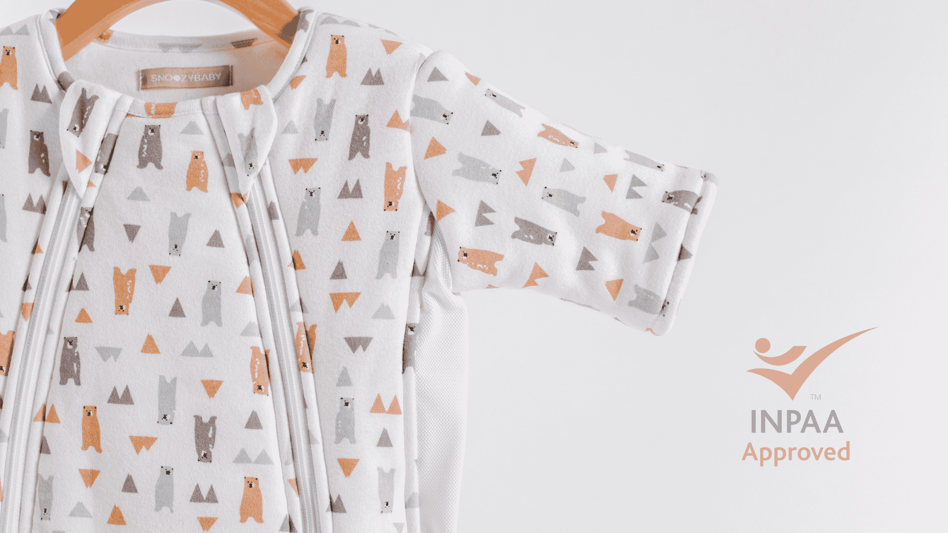 Baby sleepsuit with bear pattern and safety approved INPAA logo