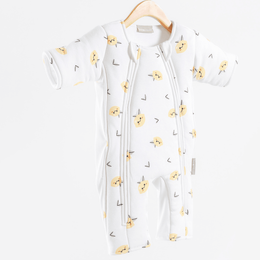 White baby sleepsuit with yellow lemon pattern on a white background