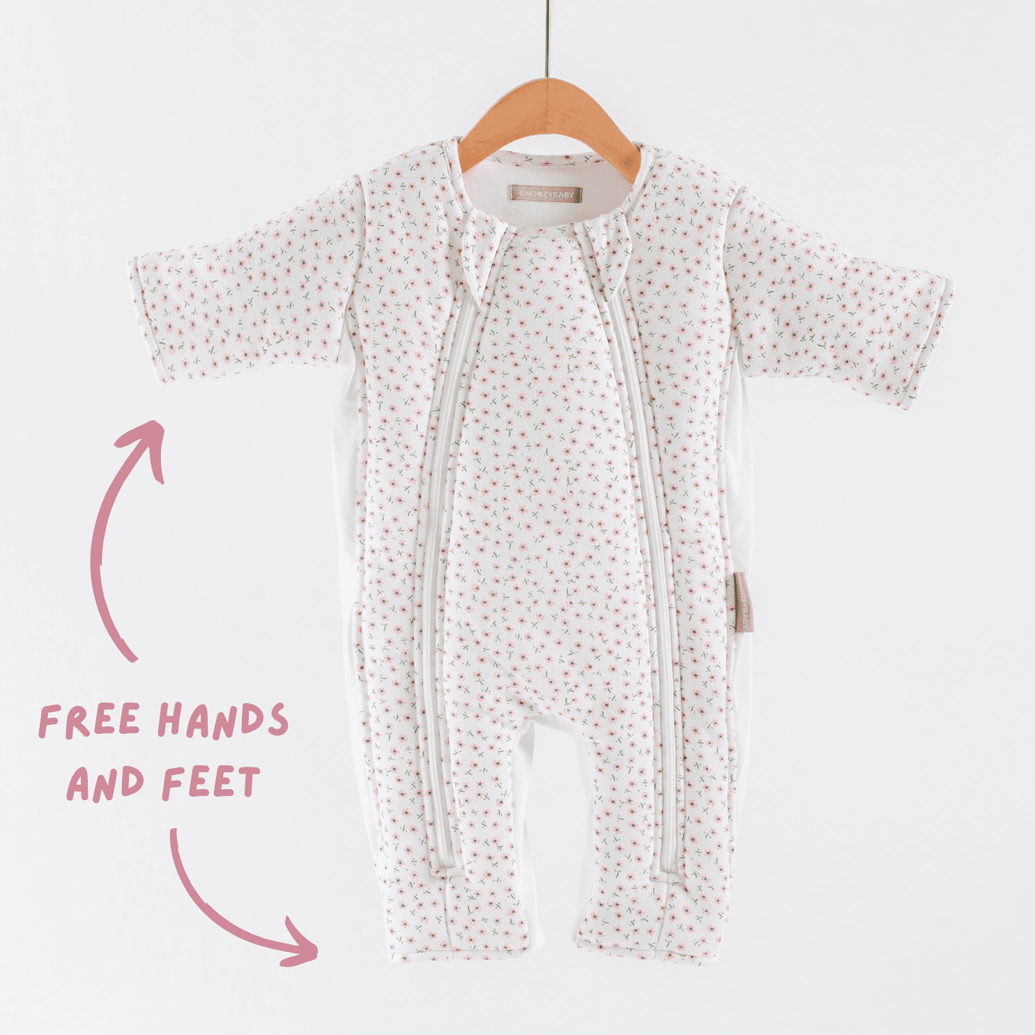 Baby transition suit with free hands and feet feature on a hanger against a white background