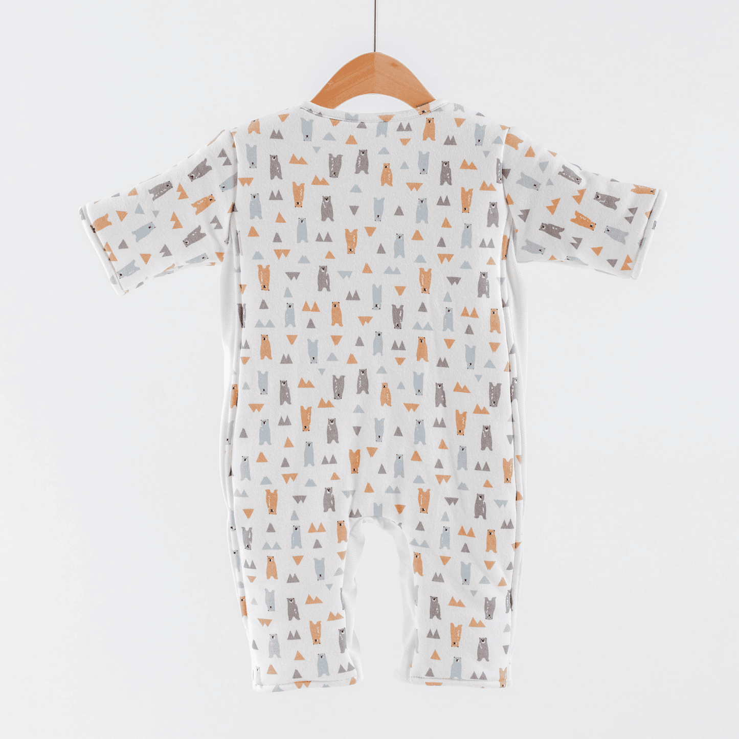 Back of baby transition suit for boys with animal pattern on a hanger against a white background