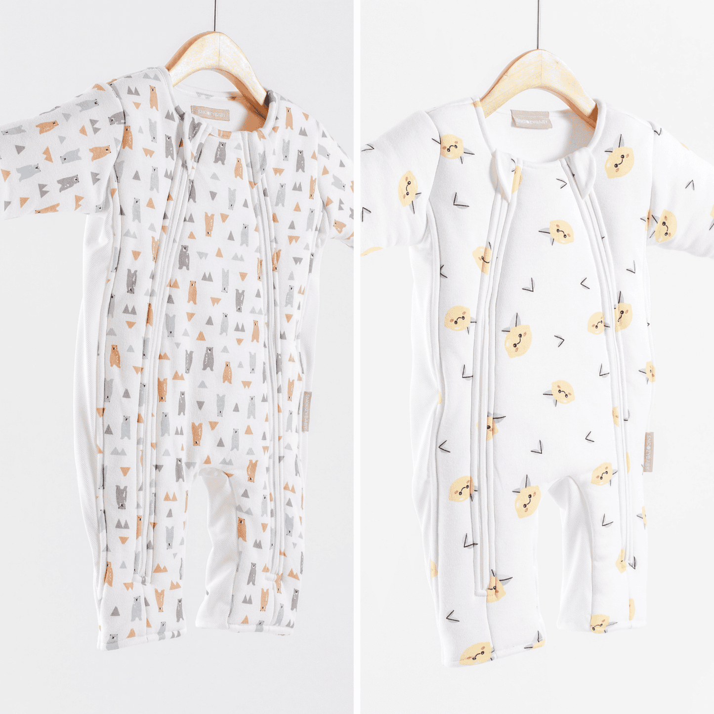 Two baby sleepsuits with different patterns on hangers against a white background