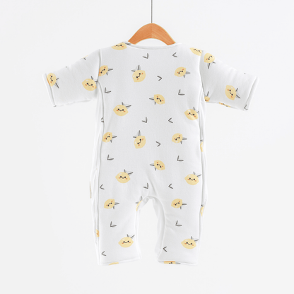Baby onesie with yellow lemon pattern on a hanger against a white background