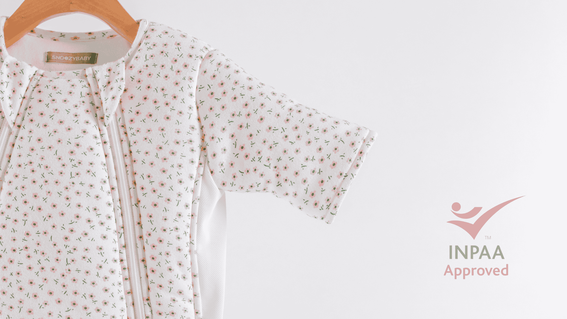 Baby transition bag with floral pattern on a hanger against a white background with INPAA Approved logo
