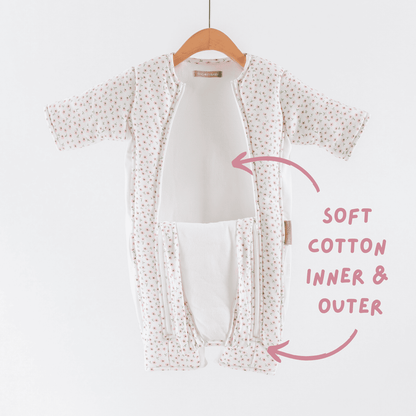 Baby transition suit with soft cotton inner and outer layers on a hanger against a white background.