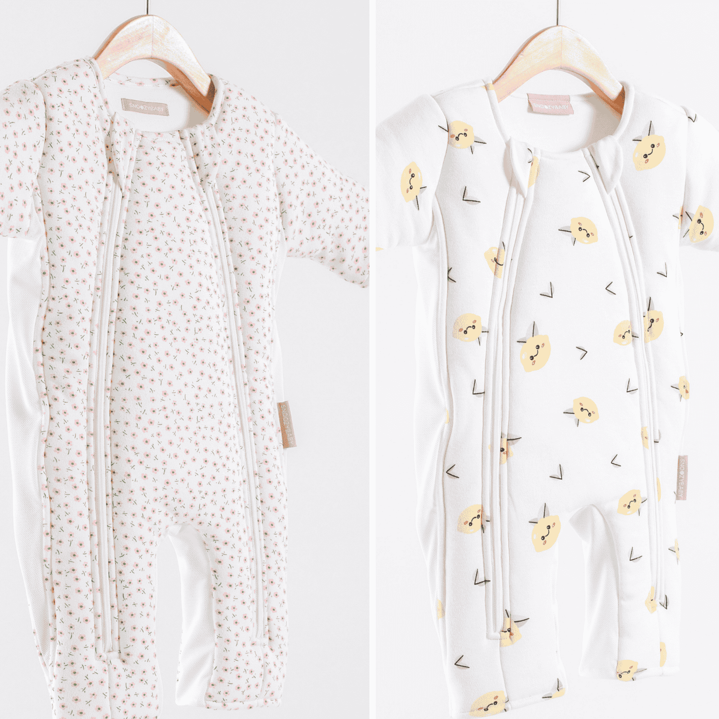 Two infant sleepsuits on hangers with different patterns against a white background
