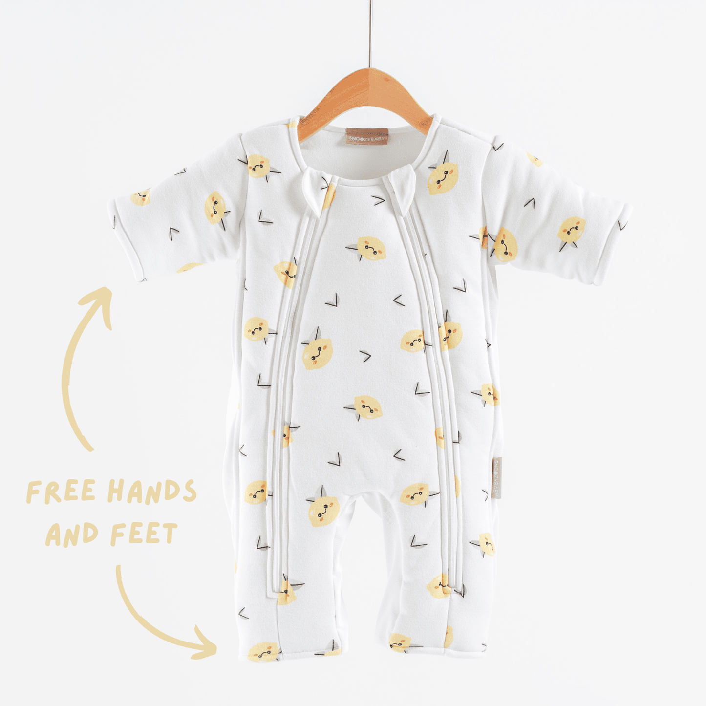 Baby sleepsuit with lemon pattern on a hanger against a white background showing open hands and feet feature