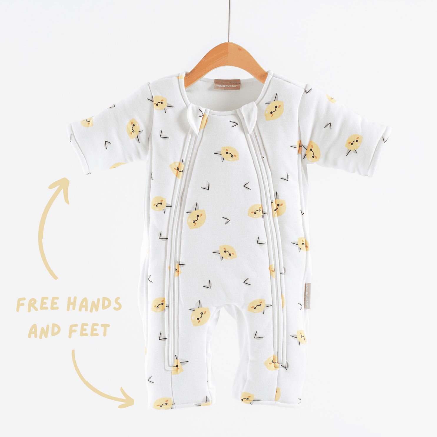Baby sleepsuit with lemon pattern on a hanger against a white background showing open hands and feet feature
